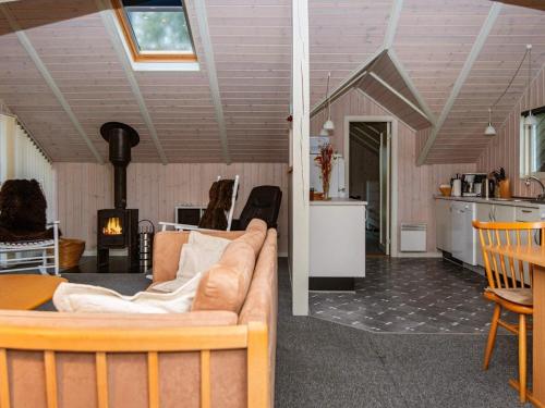 een woonkamer met een bank en een keuken bij Holiday home Ansager XLIII in Ansager