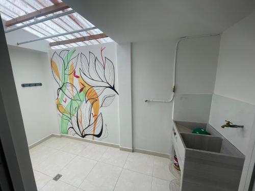 a bathroom with a mural of a flower on the wall at Duplex By Hope in Guatapé