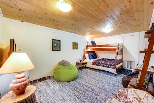 a bedroom with a bunk bed and a room with a lamp at Cloverdale Creekside Retreat in Cloverdale