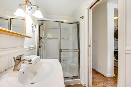 a white bathroom with a sink and a shower at Cloverdale Creekside Retreat in Cloverdale