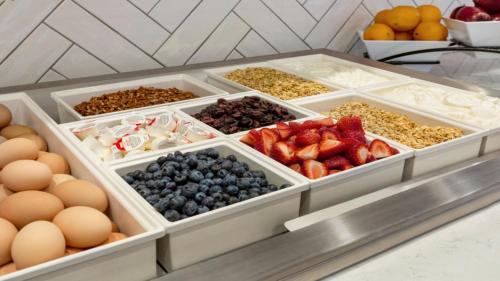 a display of fruits and vegetables in trays on a counter at Staybridge Suites - Lexington S Medical Ctr Area by IHG in Lexington