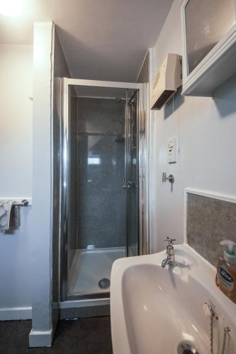 a bathroom with a shower and a sink at Kilchrist Castle Cottages in Campbeltown