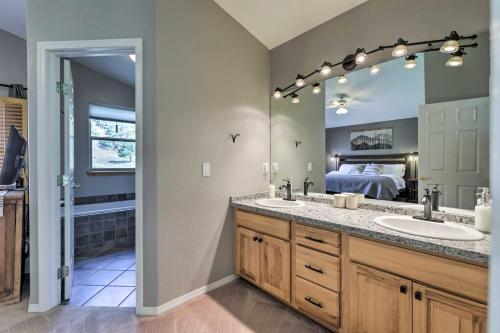 a bathroom with two sinks and a large mirror at Cozy Carbondale Escape with Deck and Grill! in Carbondale