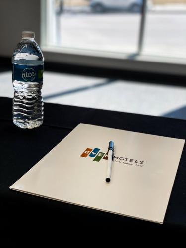 a bottle of water and a pen on a paper at EVEN Hotel Omaha Downtown - Old Market by IHG in Omaha