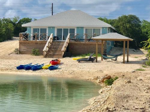 a house on the beach with boats on the shore at Sunset Cove in Forbes Hill