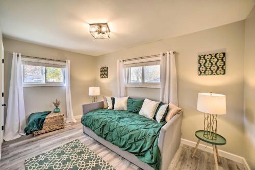 een woonkamer met een bed en 2 ramen bij Cozy Hobart Retreat Less Than 9 Mi to Lake Michigan! in Hobart