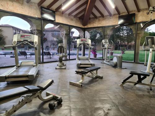 a gym with several tread machines in a building at Quinta Real Aguascalientes in Aguascalientes