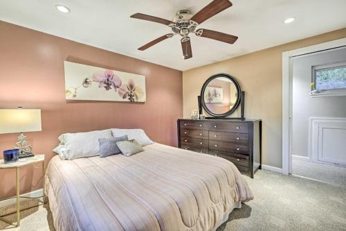 a bedroom with a bed and a ceiling fan at Cozy Dix Hills Apt with Deck about 7 Mi to Beach! in Dix Hills
