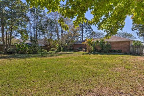 a house with a yard with a fence at Sunshine State Escape 3 Mi to Navarre Beach! in Navarre