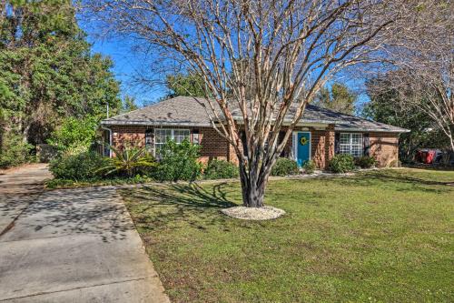 a house with a tree in the front yard at Sunshine State Escape 3 Mi to Navarre Beach! in Navarre