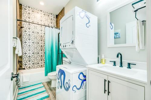a bathroom with a sink and a toilet and a shower at Sea Crest in Galveston