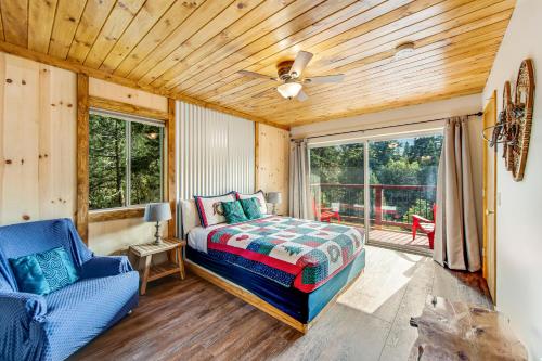 a bedroom with a bed and a couch and a ceiling fan at Black Diamond Vista in Big Bear Lake