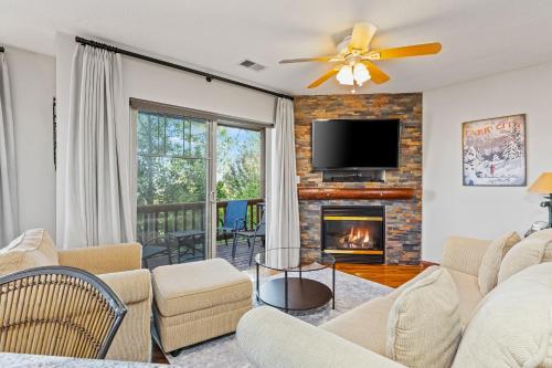 a living room with a fireplace and a tv at Jordanelle Jubilee in Heber City