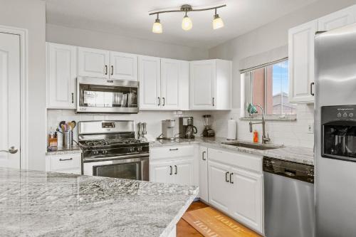 a kitchen with white cabinets and stainless steel appliances at Jordanelle Jubilee in Heber City