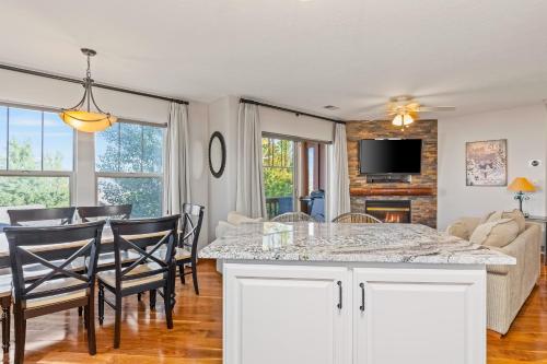 a kitchen and living room with a table and chairs at Jordanelle Jubilee in Heber City