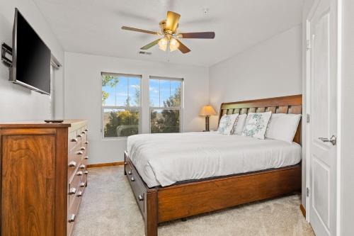 a bedroom with a bed and a ceiling fan at Jordanelle Jubilee in Heber City
