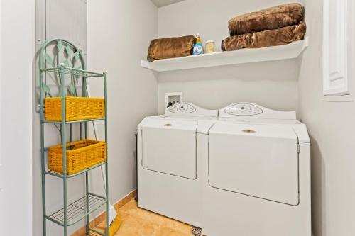 a laundry room with a washer and dryer and a shelf at Jordanelle Jubilee in Heber City
