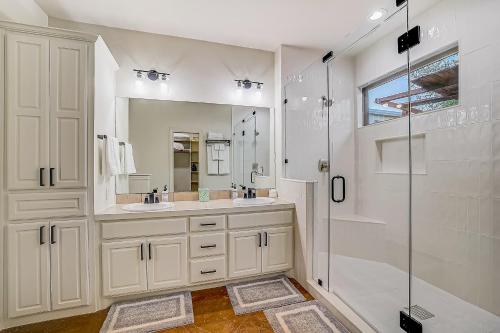 a white bathroom with a shower and a sink at Stargazer Ranch in Dripping Springs