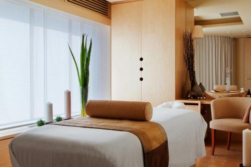 a bedroom with a bed with a plant on it at Kasara Niseko Village Townhouse in Niseko