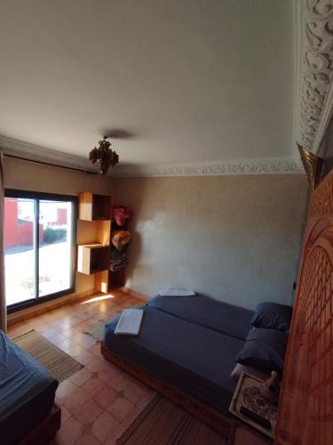 a bedroom with two beds and a window at Chillax room for 3P in Imsouane