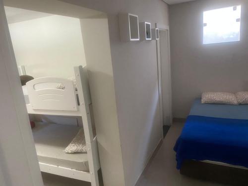 a small bedroom with a bunk bed and a ladder at Casa ao lado do parque Beto carreiro da de ir a pé para o parque João carlos casas in Penha
