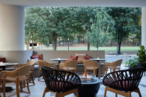 a restaurant with tables and chairs and a large window at Kimpton Shane Atlanta by IHG in Atlanta
