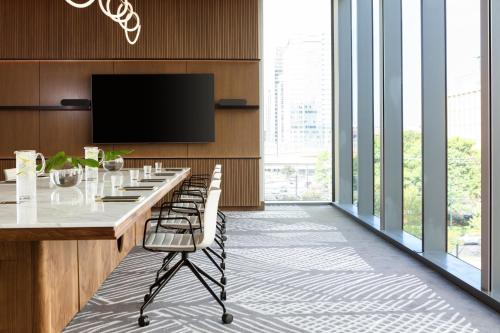 a conference room with a table and a flat screen tv at Kimpton Shane Atlanta by IHG in Atlanta