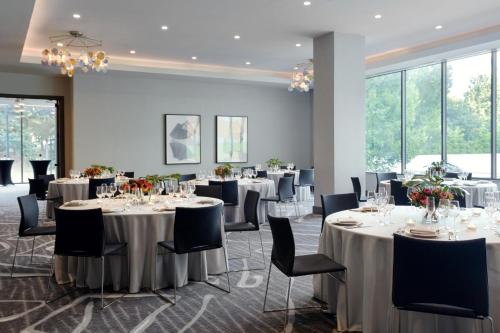 a banquet room with tables and chairs and windows at Kimpton Shane Atlanta by IHG in Atlanta
