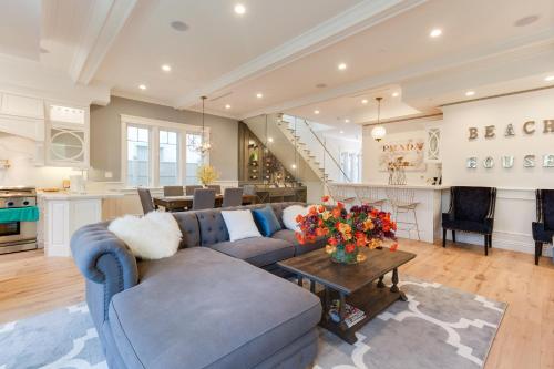 a living room with a blue couch and a table at Beautiful 2 Story Right by the Water, Ocean View in Long Beach
