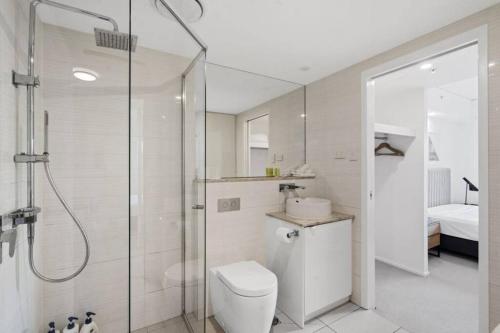 a bathroom with a shower and a toilet and a sink at Lovely 2- Bedroom Rental Unit with Free Parking in Brisbane