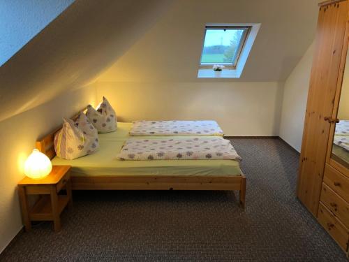 a small bedroom with a bed with a window at Graureiher in Wieck