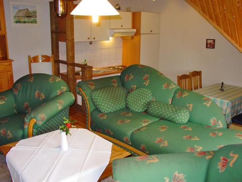 a living room with a couch and a table at Pension Martens - Gaubenwohnung in Wieck
