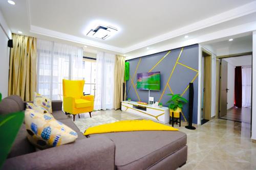 uma sala de estar com um sofá e uma televisão em Elite Luxury Apartments Kilimani - An Oasis of Serenity and Tranquility em Nairobi