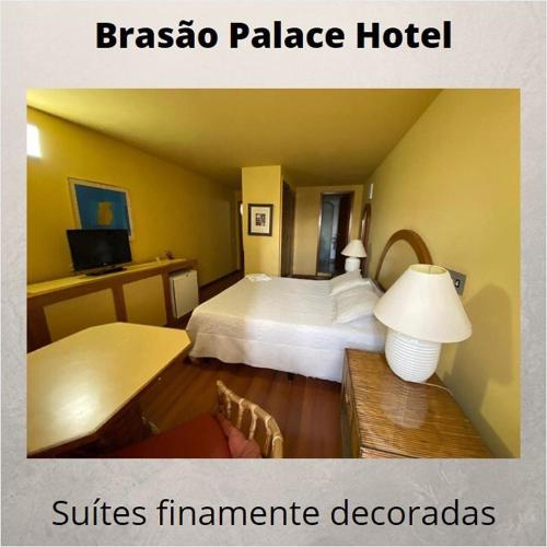 a hotel room with a bed and a table at Brasao Palace Hotel in Presidente Prudente