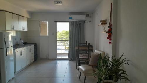 a kitchen with a refrigerator and a table and chairs at Departamento Barrio Candioti in Santa Fe