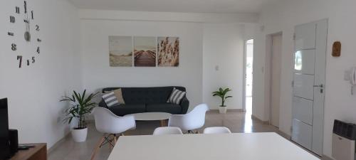 sala de estar con mesa y sillas blancas en Alojamientos Litoral - 3 B en Gualeguaychú