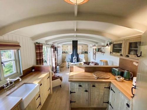 a kitchen with a sink and a stove at Little Red House - Uk41233 in Shelve