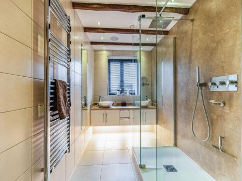 a bathroom with a glass shower and a sink at Flint Barn in Doddington