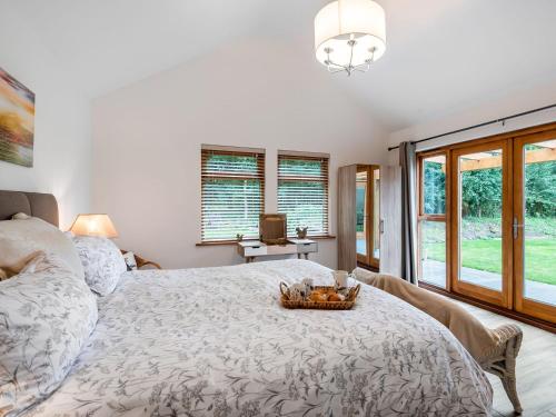 a bedroom with a bed with a bowl of fruit on it at North Farm Lodge in East Mersea