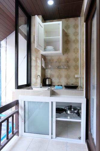 a small kitchen with a sink and a window at Arina Boutique Residence in Chaweng