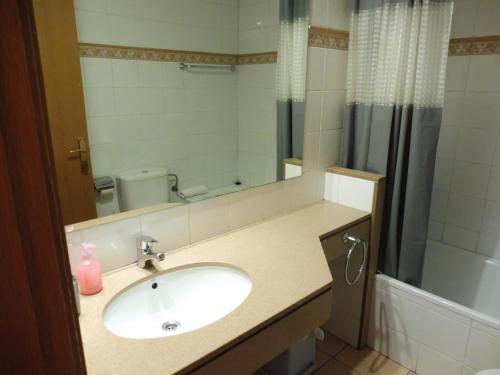 a bathroom with a sink and a shower at Hostal Cal Batista in Bagá