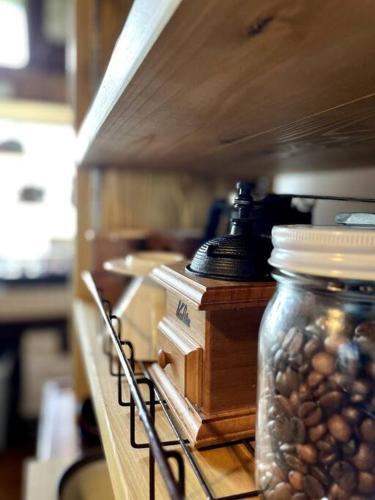 a shelf with a jar of beans and a microscope at KOME HOME in Tokamachi