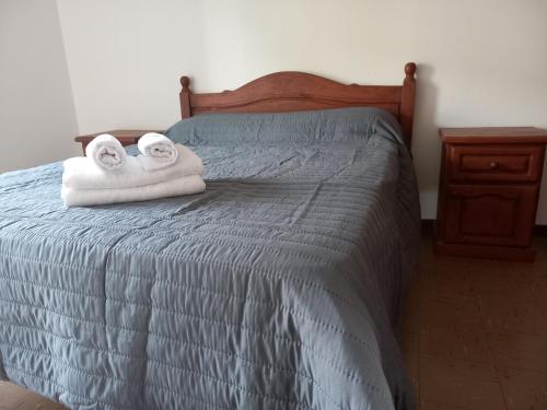 a bedroom with a bed with two towels on it at Temporario Salta in Salta