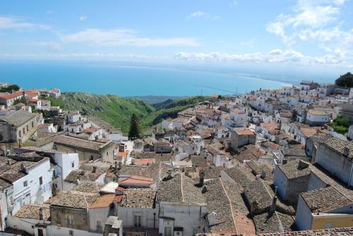 an aerial view of a city with the ocean at Albergo Casa Del Pellegrino in Monte SantʼAngelo
