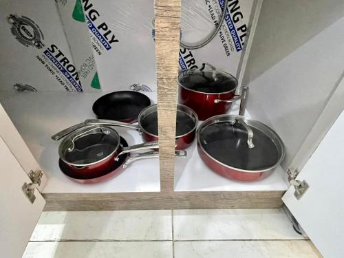 three pots and pans are sitting on a shelf at Porta Del Sol CV in Tamarindo