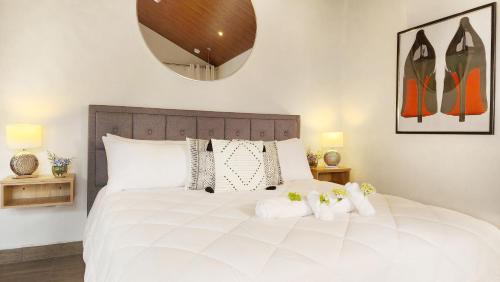 a bedroom with a large white bed with two white towels at Rio Verde by Villa Alejandro in Boquete