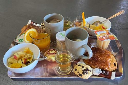 una bandeja de alimentos para el desayuno y bebidas en una mesa en chalet Ti kaz pitaya en Le Tampon