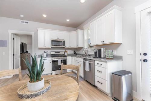 a kitchen with white cabinets and a potted plant at Charming 3-bedroom in vibrant new neighborhood in Billings