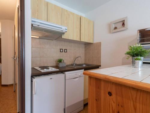 a kitchen with a sink and a counter top at Appartement confortable 4 pers avec parking et casier à ski à Vielle-Aure - FR-1-296-206 in Vielle-Aure