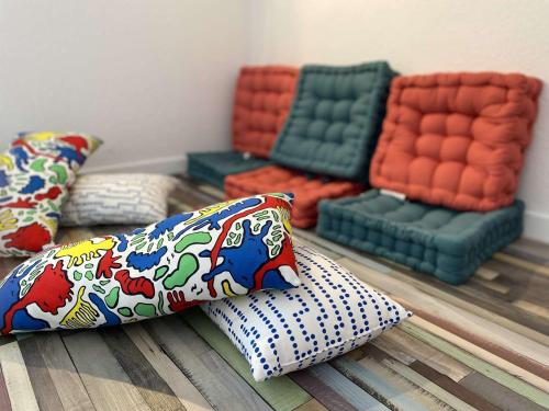 a group of pillows sitting on the floor in a room at Duplex à Combrit: plage à pied, piscine chauffée et tennis - FR-1-481-101 in Combrit